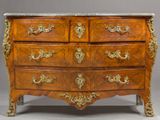 an antique chest of drawers with a marble top and gold accents