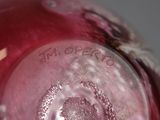 a close up view of a glass vase with a red base