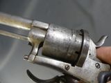a person holding a silver revolver in their hand