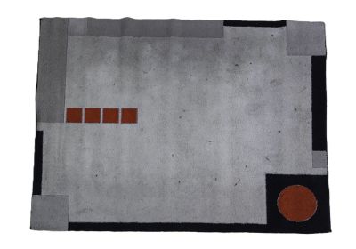 a close up of a rug on a white surface with a red dot