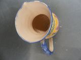 a blue and white cup with a handle on a table