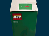 a green box that has a lego figure on top of it