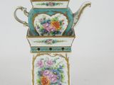 a blue and white teapot with flowers on it