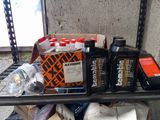 many bottles of motor oil and other items on a shelf