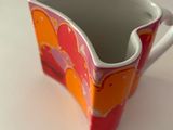 a cup that is sitting on a white table