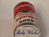 a can of soup sitting on a table next to a knife