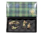 four figurines of soldiers in a black box