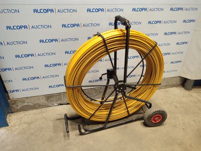 a yellow hose that is on a cart in a room