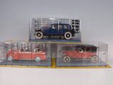 three toy cars that are sitting in a display case