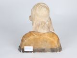 a statue of a woman sitting on a rock
