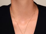 a woman wearing a black shirt and a gold necklace