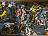 a cardboard box full of assorted toy items