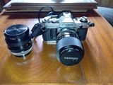 a camera sitting on top of a wooden table next to a camera