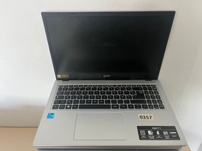 an open laptop computer sitting on top of a wooden table