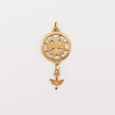 a close up of a gold charm with a bird on it