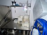 a small kitchen with a sink and a metal counter