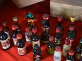 many bottles of wine on a red table cloth