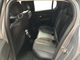 the back seats of a car with the door open and the driver ' s seat down