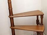 an image of a corner of a room with a chair and bookshelf