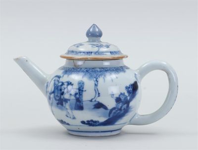 une théière bleue et blanche avec un couvercle, posée sur une table blanche