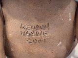 a brown vase with writing on it sitting on a table