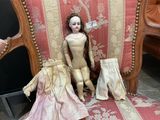 a doll sitting on a chair next to other dolls