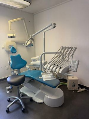 a dentist ' s chair in the corner of the room