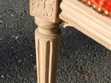 a close up of a chair with a red upholstered seat
