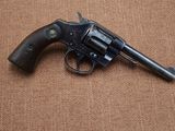 a close up of a revolver on a brown background