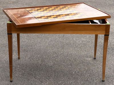 une table en bois sur laquelle est posé un plateau à damier