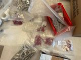 many different types of screws and nuts on the table