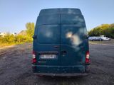a blue van that is parked on the side of the road