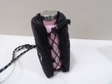 a pink bottle with a black cover on a white table