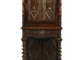 an old wooden cabinet with carvings on the top of it