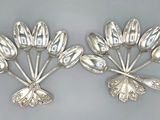 pair of silver plated spoons with flowers and leaves
