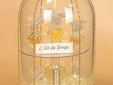 a glass birdcage with a bird inside of it