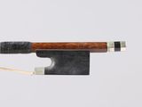 a bow with a wooden handle on a white surface