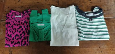 three shirts are lined up on a wooden floor next to each other
