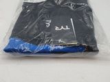 a plastic bag of black clothing on a white surface