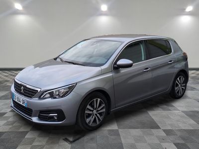 a silver car parked in a garage with a checkered floor