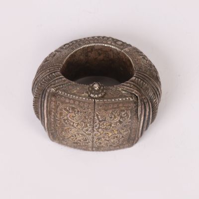 an old silver ring with a decorative design on it