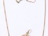 three pieces of jewelry including a necklace, ring, and earring