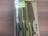 three knives in the package on the table