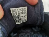 a hand that is holding a shoe that has a label on it