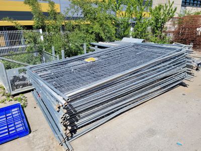 a pile of steel bars on the ground next to a blue crate