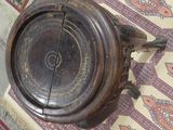 an old wooden bowl on a rug on the floor