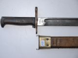 two knives that are laying on a white surface