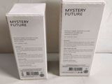 two boxes of mystery future perfume sitting next to each other