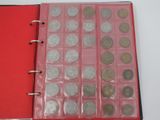 a red book with a bunch of coins inside of it