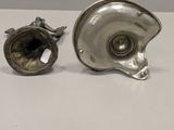 two silver plated objects on a white surface